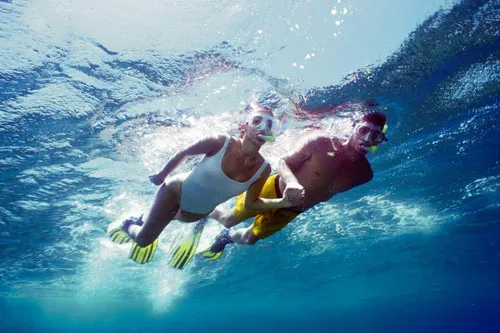 Young couple snorkeling on sea surface